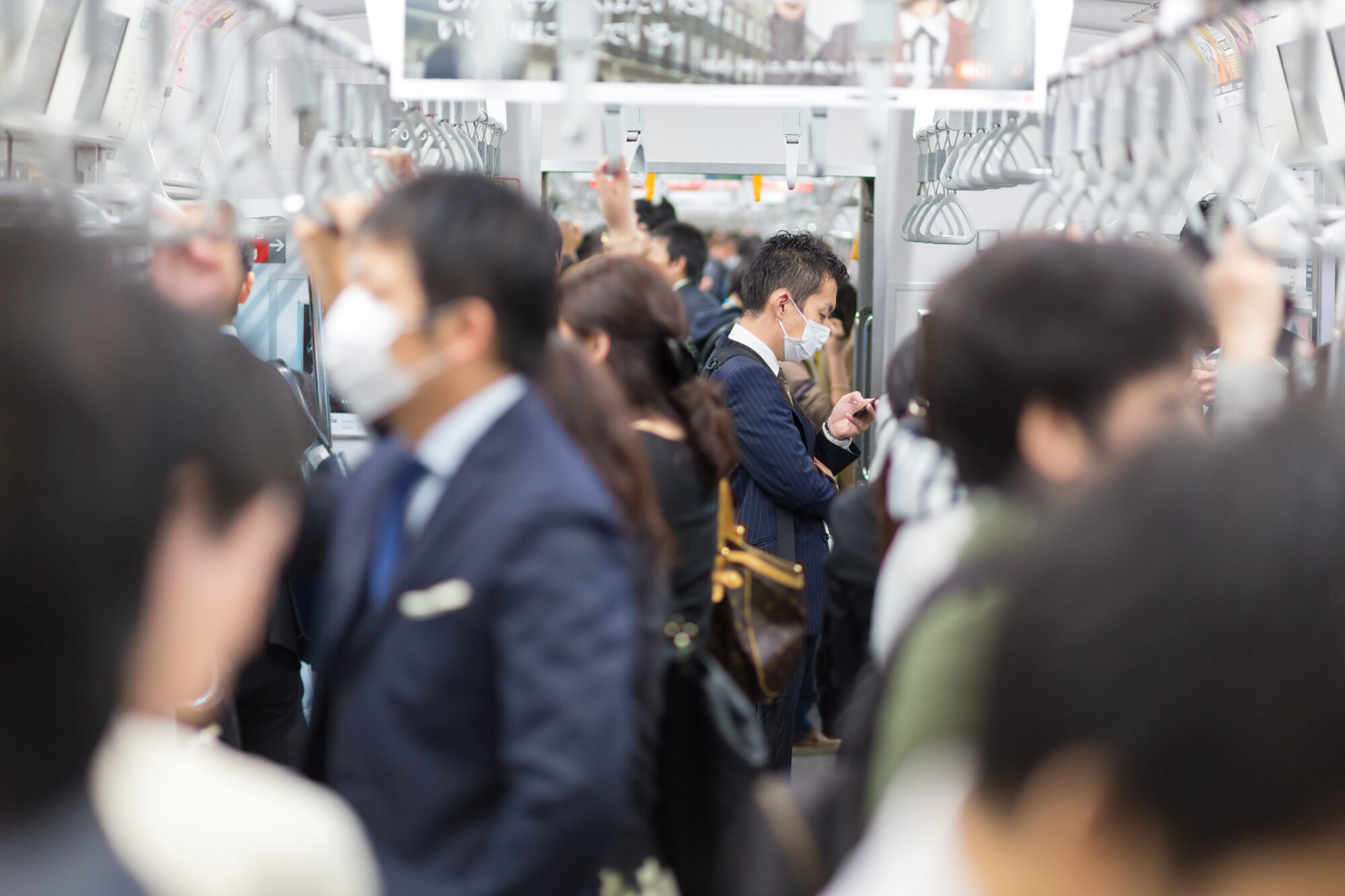 Passengers traveling by Tokyo metro.